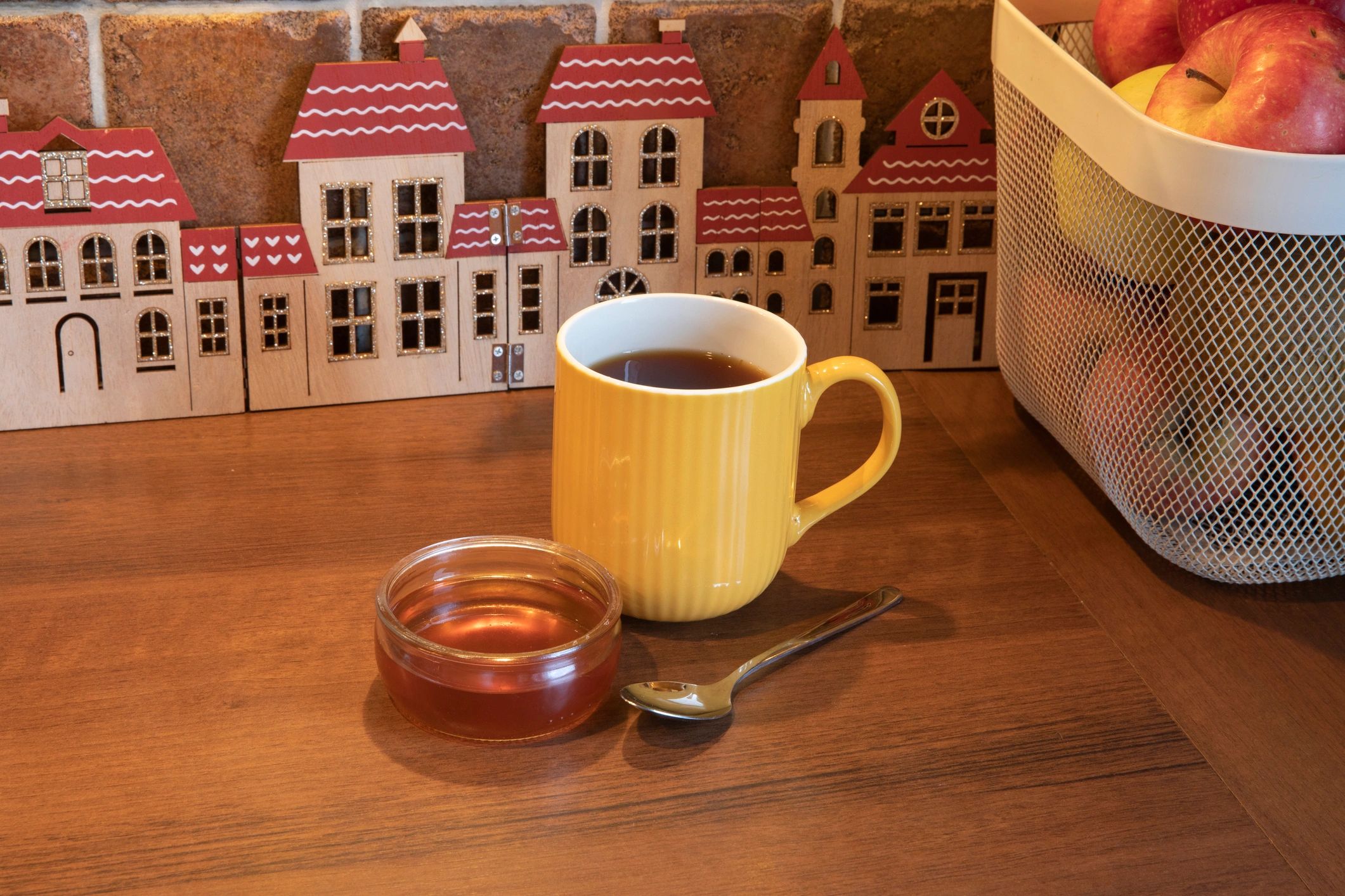Honey jar and tea on a wooden table
